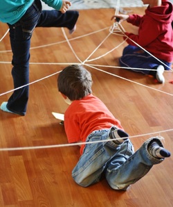 Building Yarn Spiderwebs - Great fine motor AND large motor activity for kids! - Hilary's Home Daycare